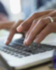 Man Typing on a Laptop